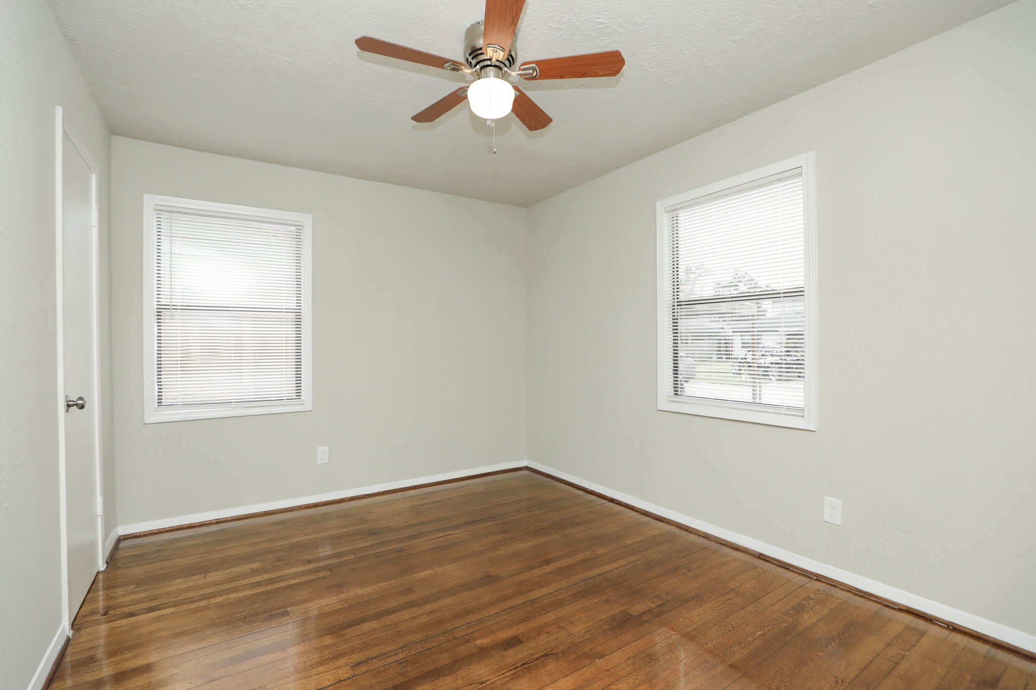 718 Champs Street Channelview, TX 77530 - Photo 24 of 31 a view of empty room with wooden floor and fan