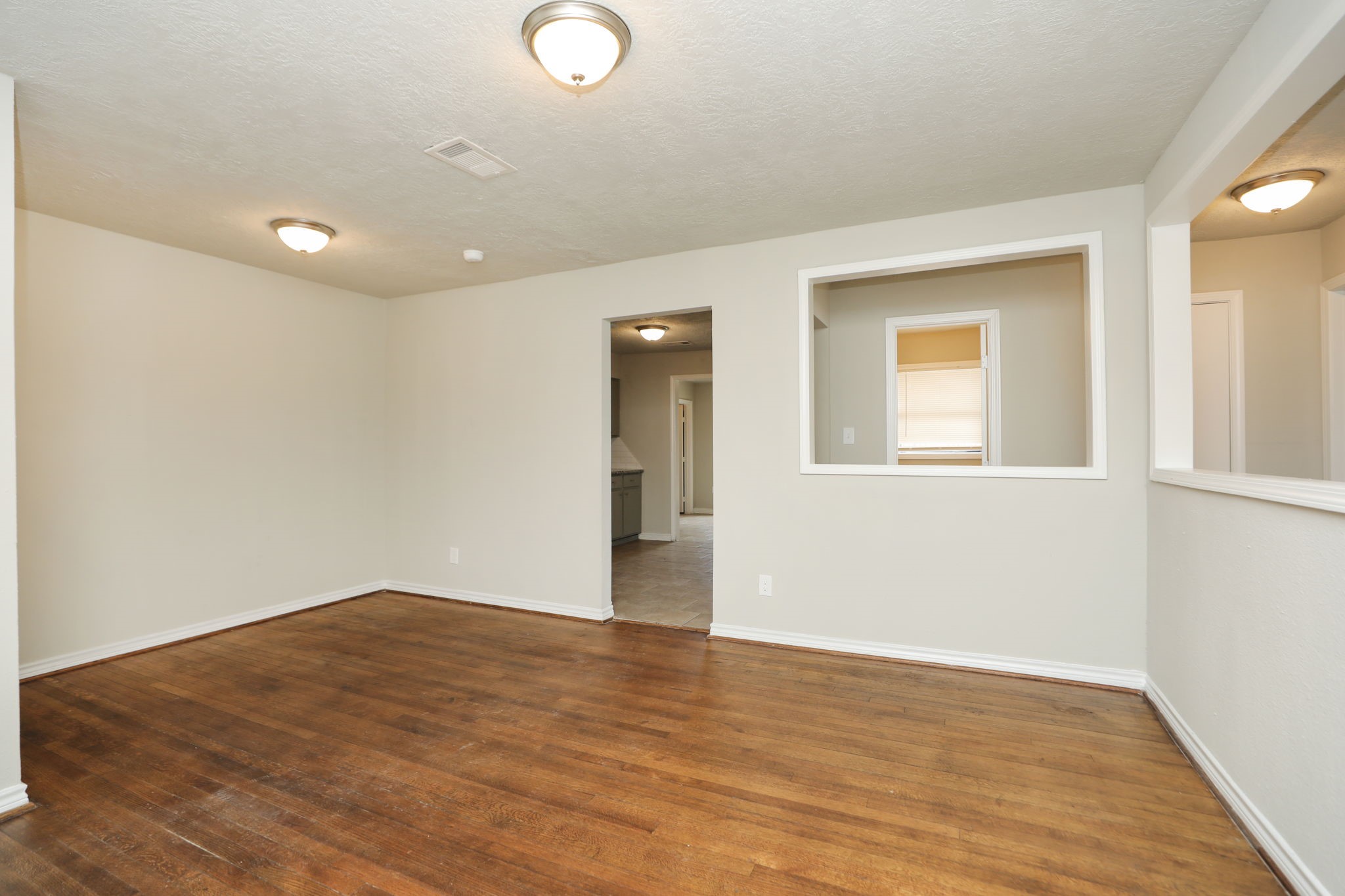 718 Champs Street Channelview, TX 77530 - Photo 3 of 31 a view of empty room with wooden floor and fan