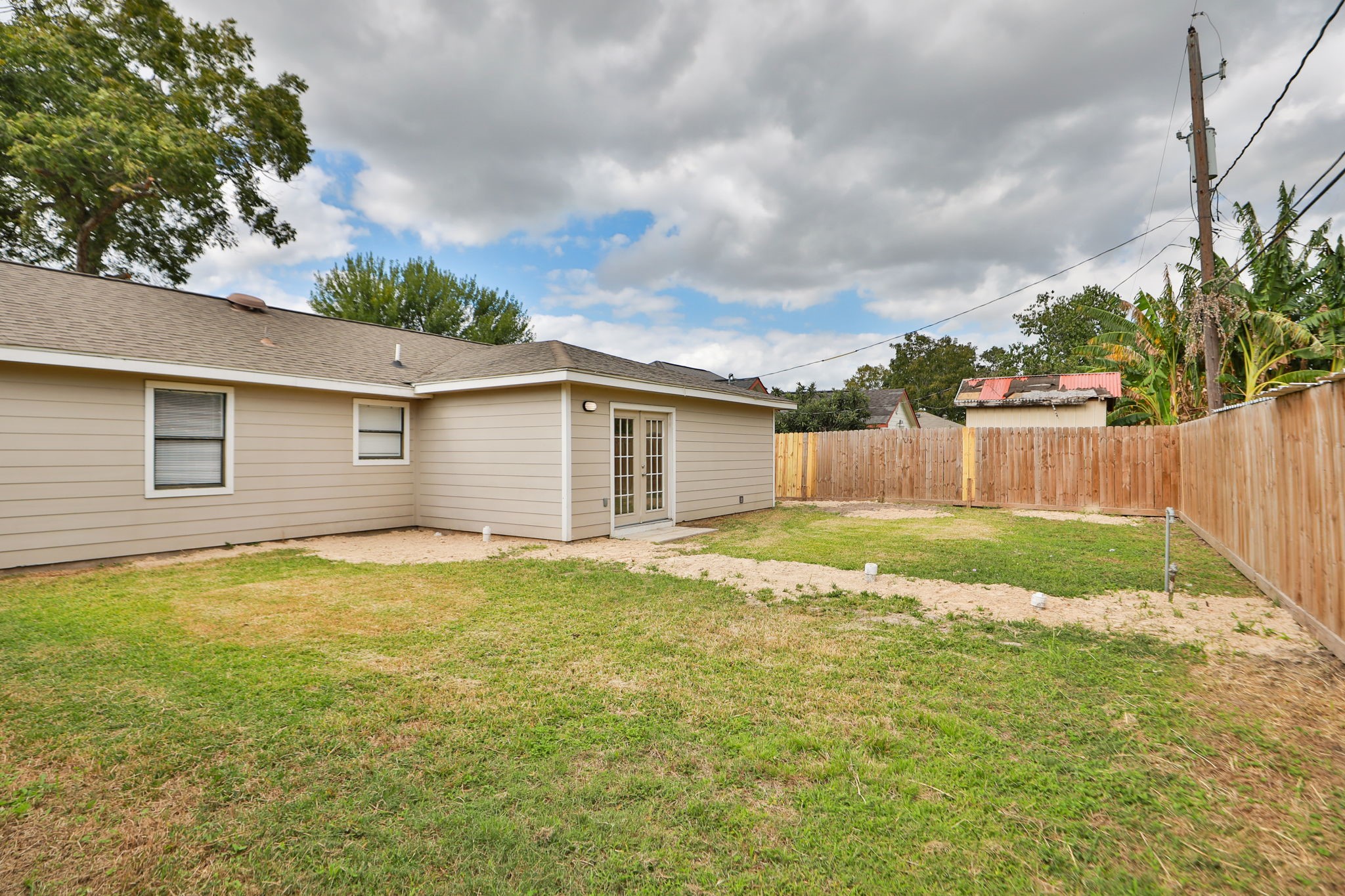 718 Champs Street Channelview, TX 77530 - Photo 31 of 31 a view of a backyard with table and chairs and wooden fence