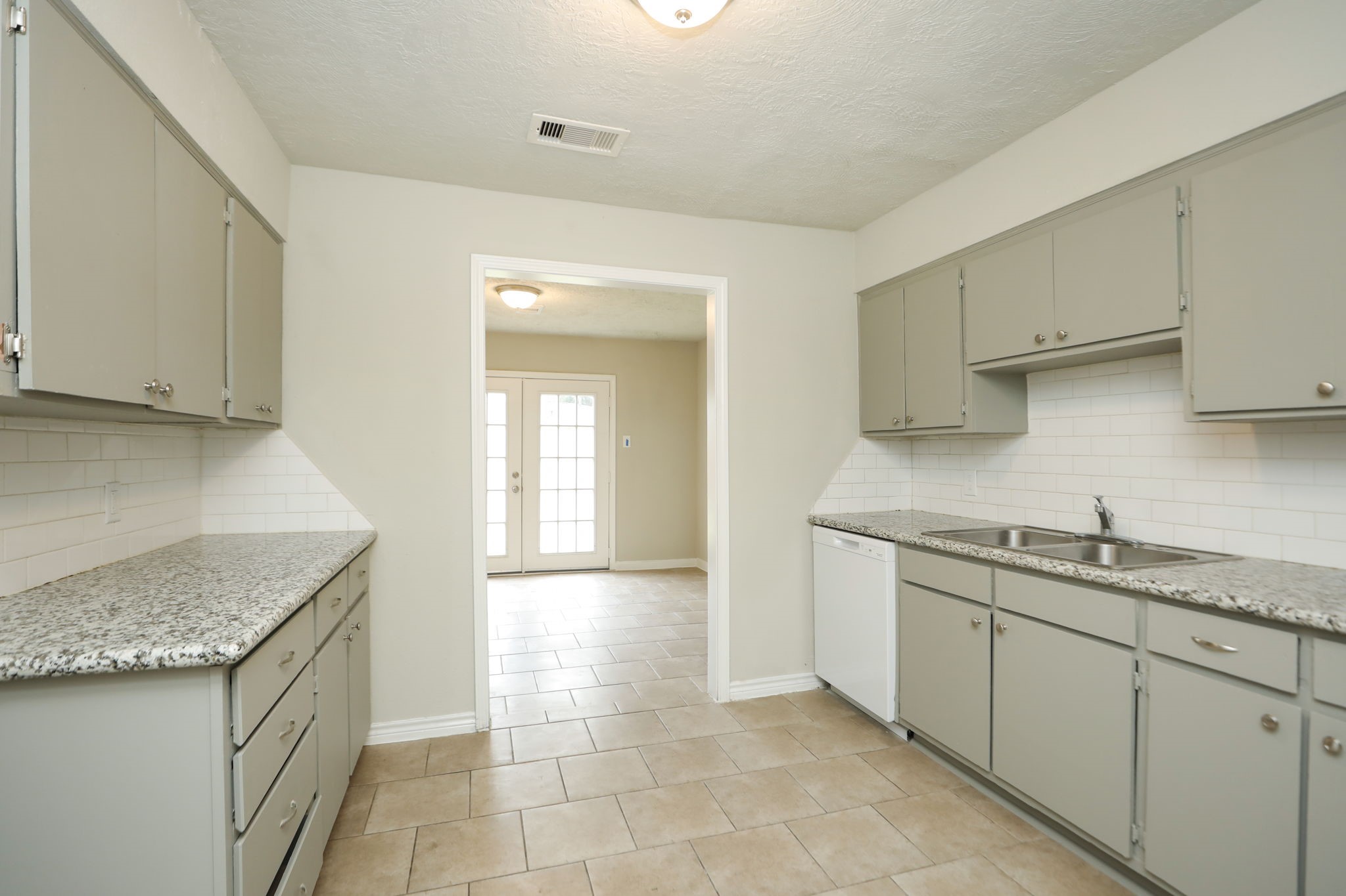 718 Champs Street Channelview, TX 77530 - Photo 8 of 31 a kitchen with a sink stove and cabinets