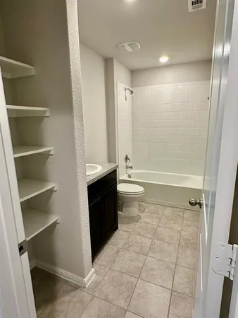 a bathroom with a bathtub and toilet