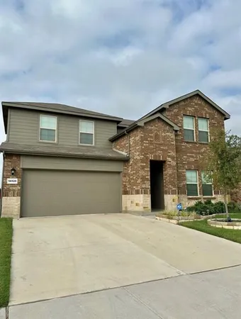 a front view of a house with garage