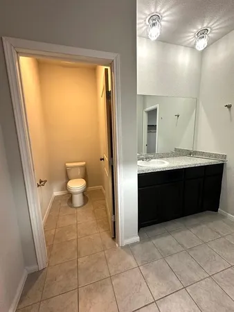a bathroom with a sink vanity and a toilet