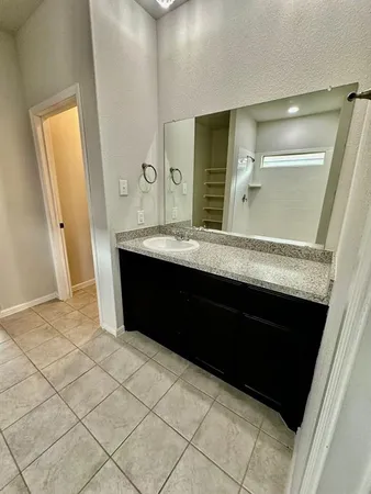 a bathroom with a double vanity sink and mirror