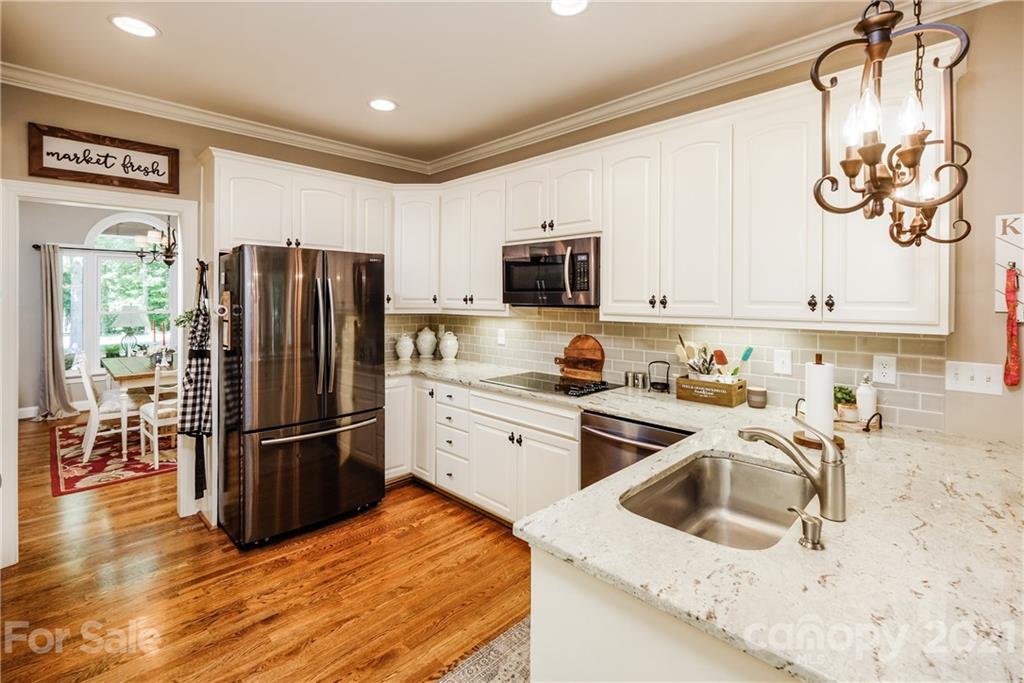 1172 Ben Black Road Midland, NC 28107 - Photo 12 of 48 a kitchen with granite countertop a refrigerator stove and sink
