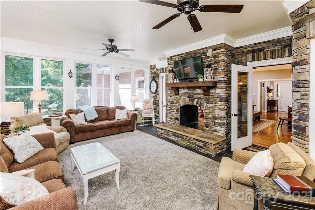 1172 Ben Black Road Midland, NC 28107 - Photo 15 of 48 a living room with furniture a flat screen tv and a fireplace