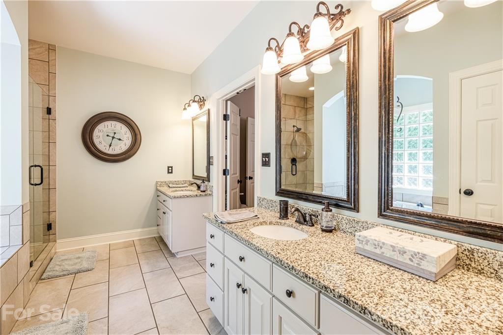 1172 Ben Black Road Midland, NC 28107 - Photo 20 of 48 a spacious bathroom with a granite countertop sink and a mirror