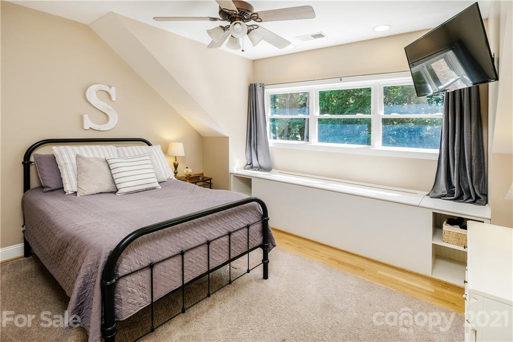 1172 Ben Black Road Midland, NC 28107 - Photo 30 of 48 a bedroom with a large bed and a chandelier