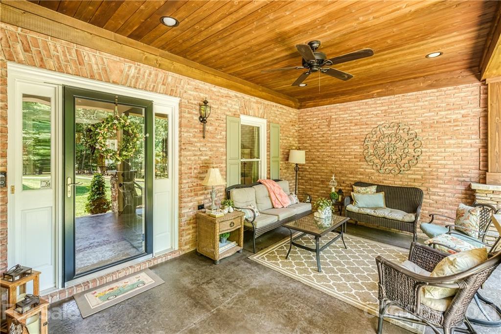 1172 Ben Black Road Midland, NC 28107 - Photo 4 of 48 a living room with patio furniture and a floor to ceiling window