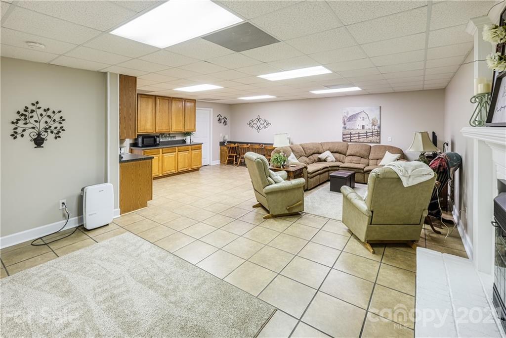 1172 Ben Black Road Midland, NC 28107 - Photo 33 of 48 a living room with fireplace furniture and a flat screen tv