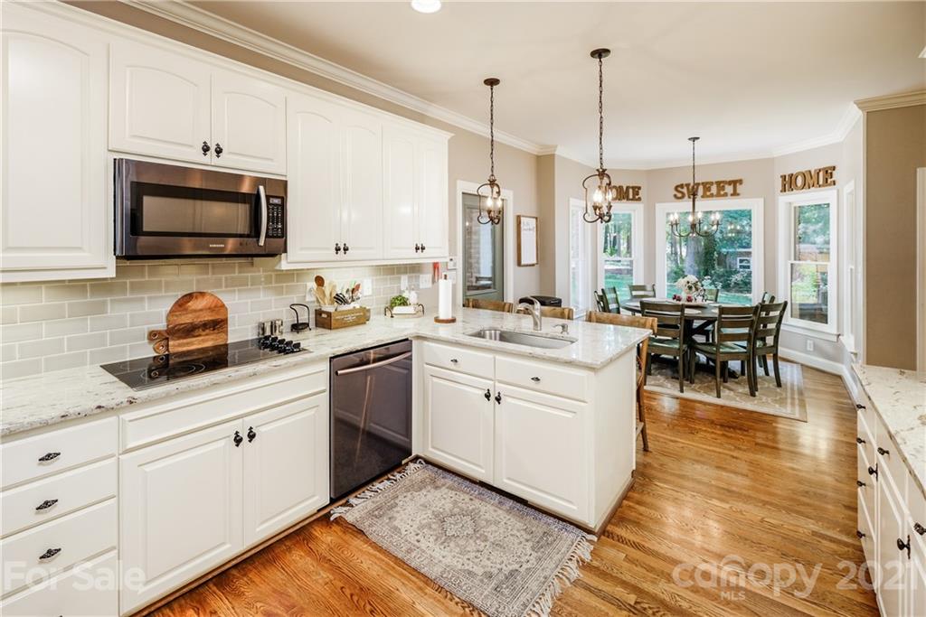 1172 Ben Black Road Midland, NC 28107 - Photo 10 of 48 a kitchen with a sink stove and white cabinets