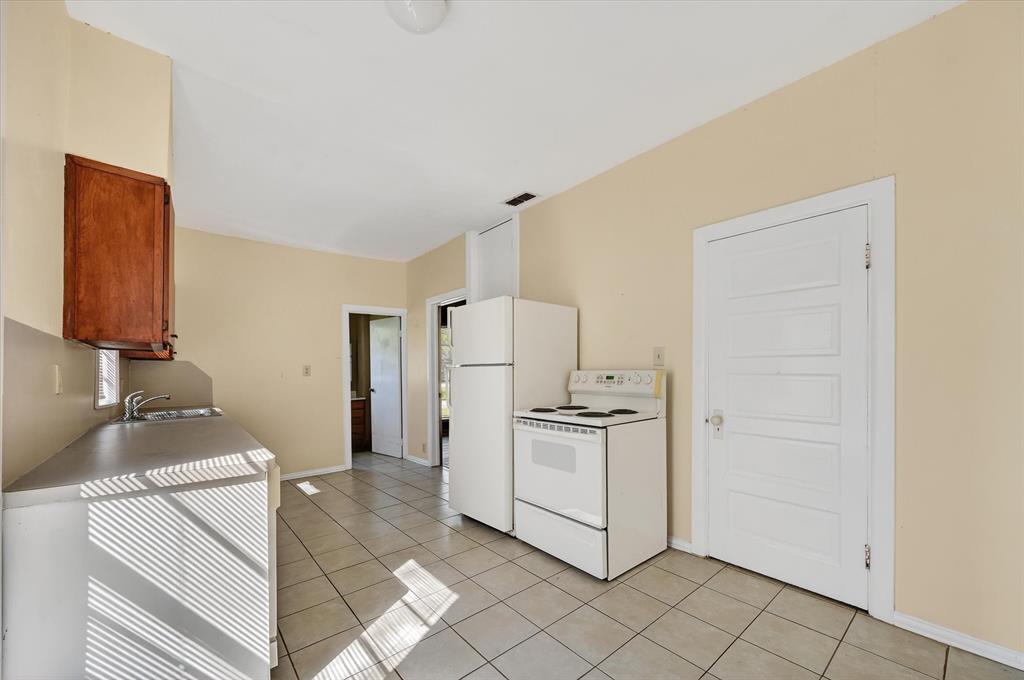 800 South Jefferson Street Pilot Point, TX 76258 - Photo 13 of 27 a kitchen with stainless steel appliances cabinets and a counter top space