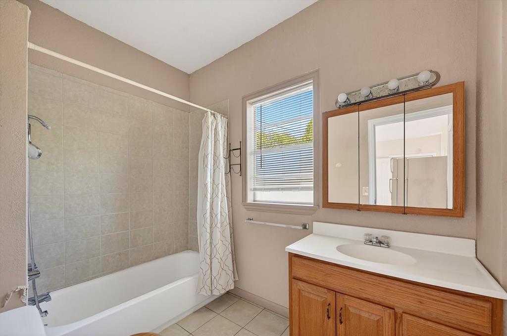 800 South Jefferson Street Pilot Point, TX 76258 - Photo 18 of 27 a bathroom with a sink and a bathtub