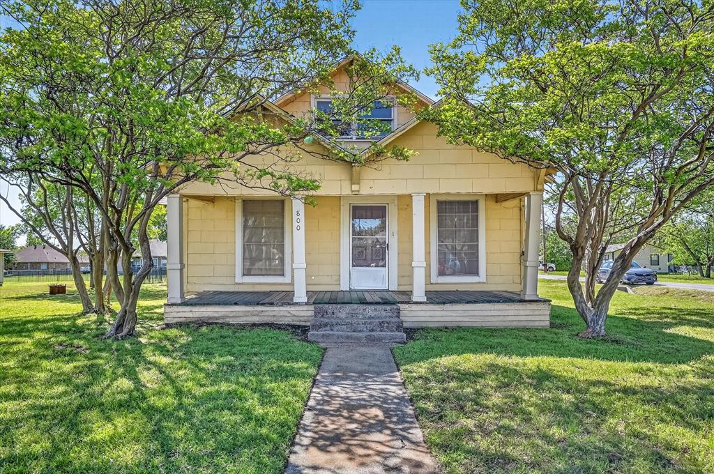 800 South Jefferson Street Pilot Point, TX 76258 - Photo 25 of 27 a front view of a house with garden