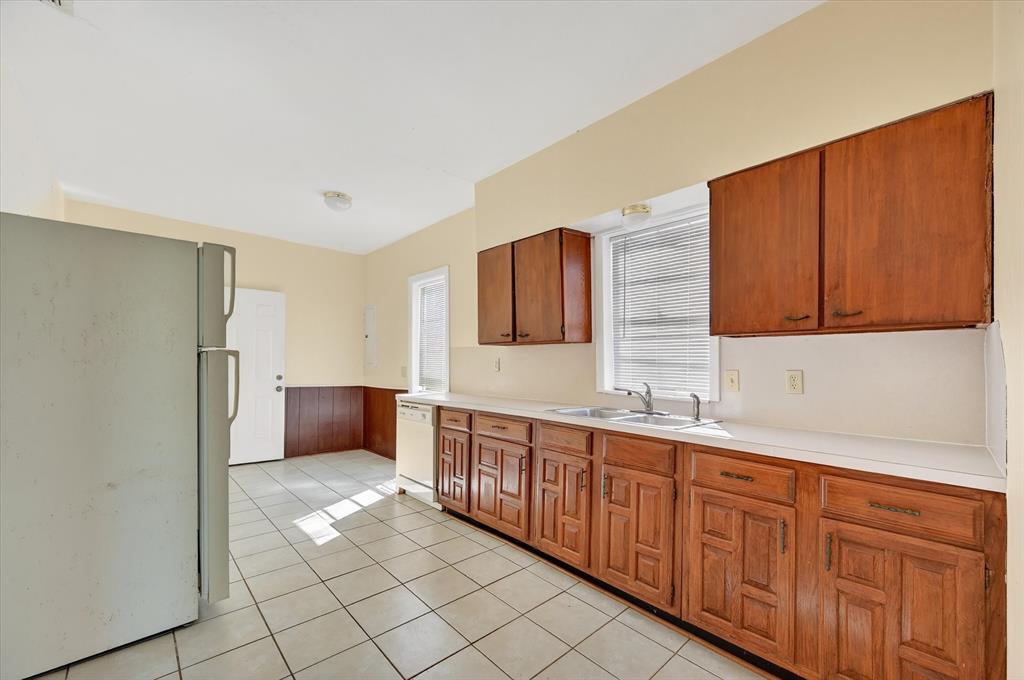 800 South Jefferson Street Pilot Point, TX 76258 - Photo 8 of 27 a view of a kitchen with stainless steel appliances granite countertop a refrigerator and a sink
