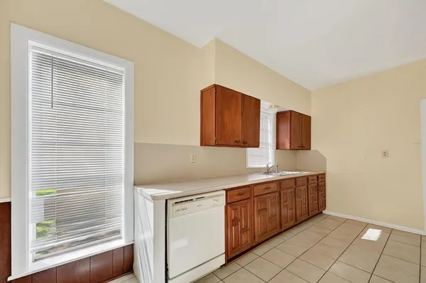 a kitchen with a sink cabinets and window