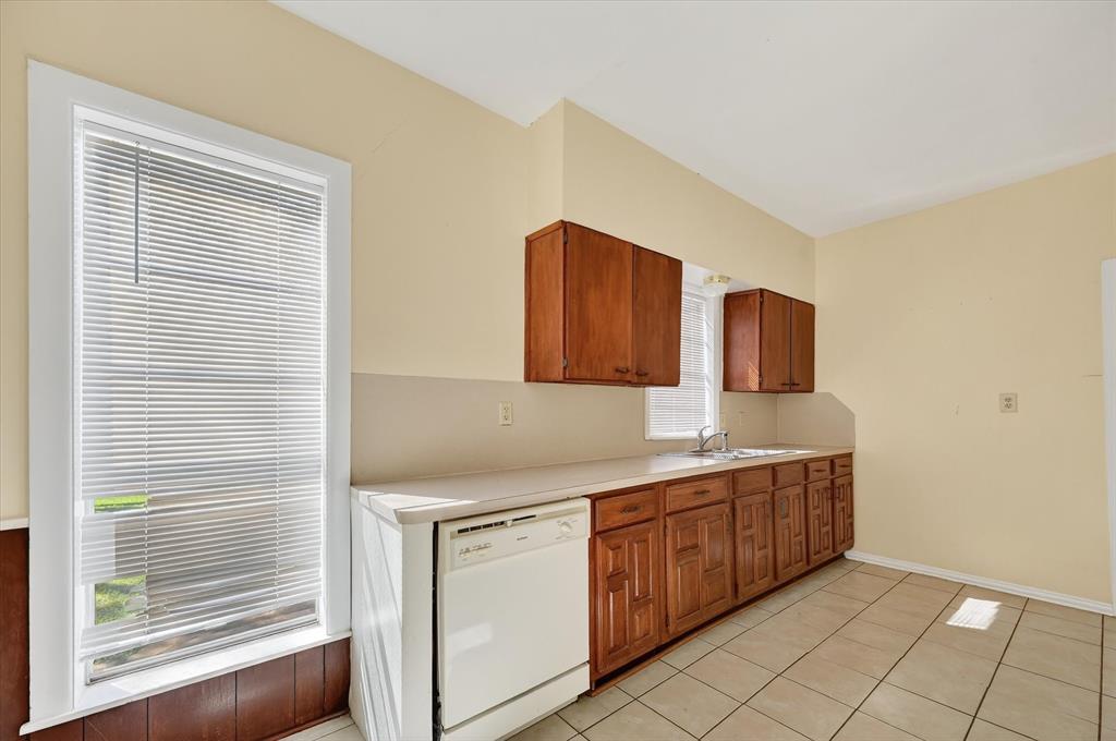 800 South Jefferson Street Pilot Point, TX 76258 - Photo 9 of 27 a kitchen with a sink cabinets and window