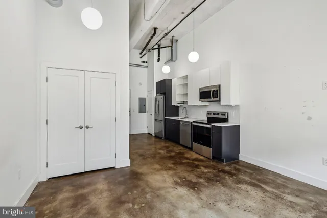 a kitchen with stainless steel appliances a refrigerator and a stove