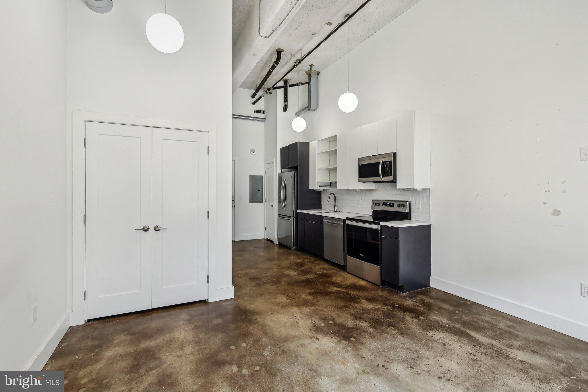 2000 North 2nd Street, Unit 404 Philadelphia, PA 19122 - Photo 6 of 9 a kitchen with stainless steel appliances a refrigerator and a stove
