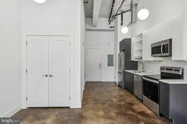 a kitchen with stainless steel appliances a refrigerator and a stove top oven