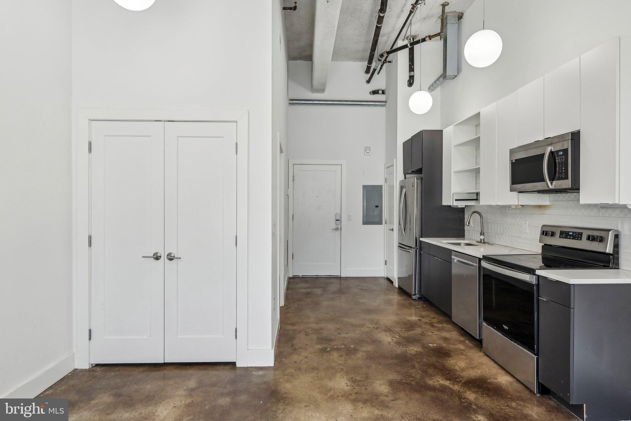2000 North 2nd Street, Unit 404 Philadelphia, PA 19122 - Photo 8 of 9 a kitchen with stainless steel appliances a refrigerator and a stove top oven