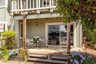 a view of a balcony with chairs potted plants