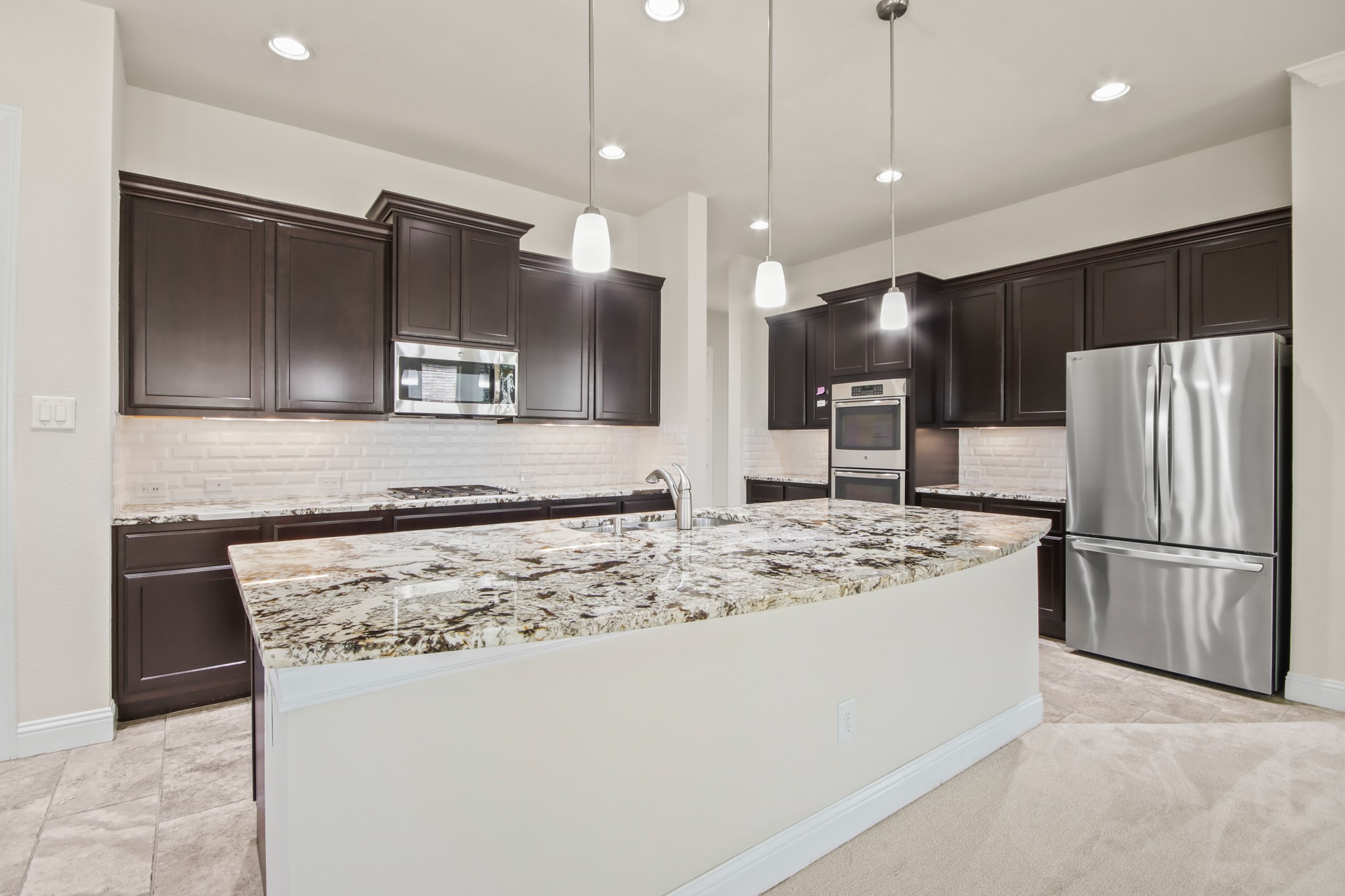 8931 Leaning Hollow Lane Spring, TX 77379 - Photo 7 of 38 The Gourmet Kitchen has beautiful high grade Granite Counters, Stainless Steel Appliances, recessed lighting and a huge Island w/the Kitchen Sink.