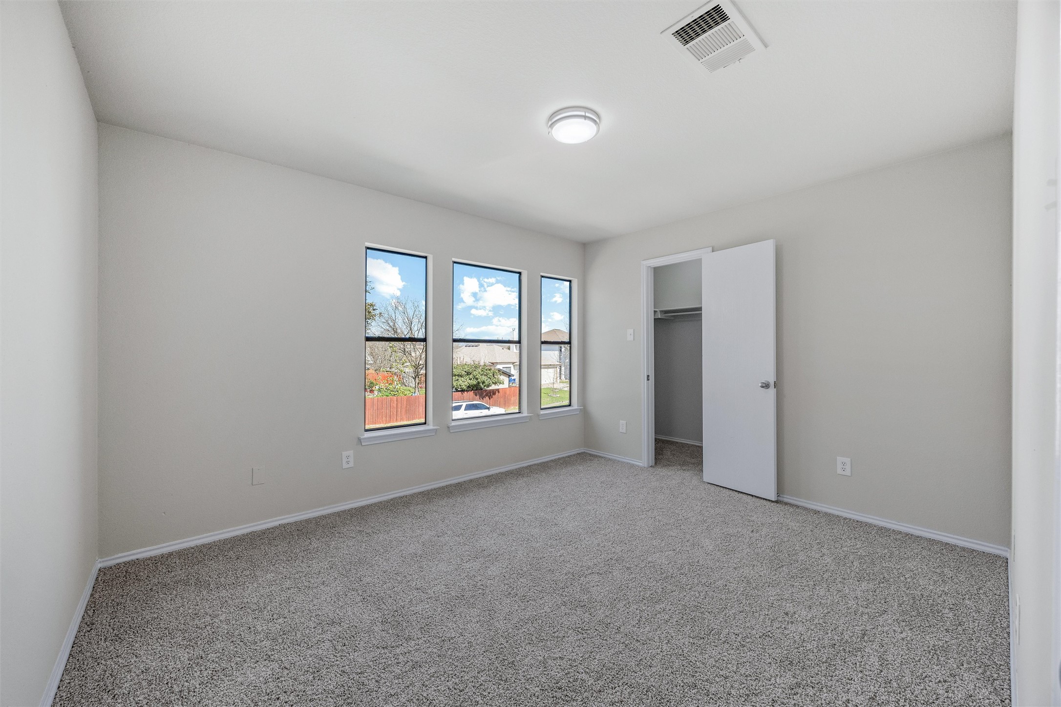 7541 Redrick Drive Austin, TX 78747 - Photo 35 of 40 Unfurnished bedroom featuring visible vents, baseboards, a spacious closet, and carpet flooring
