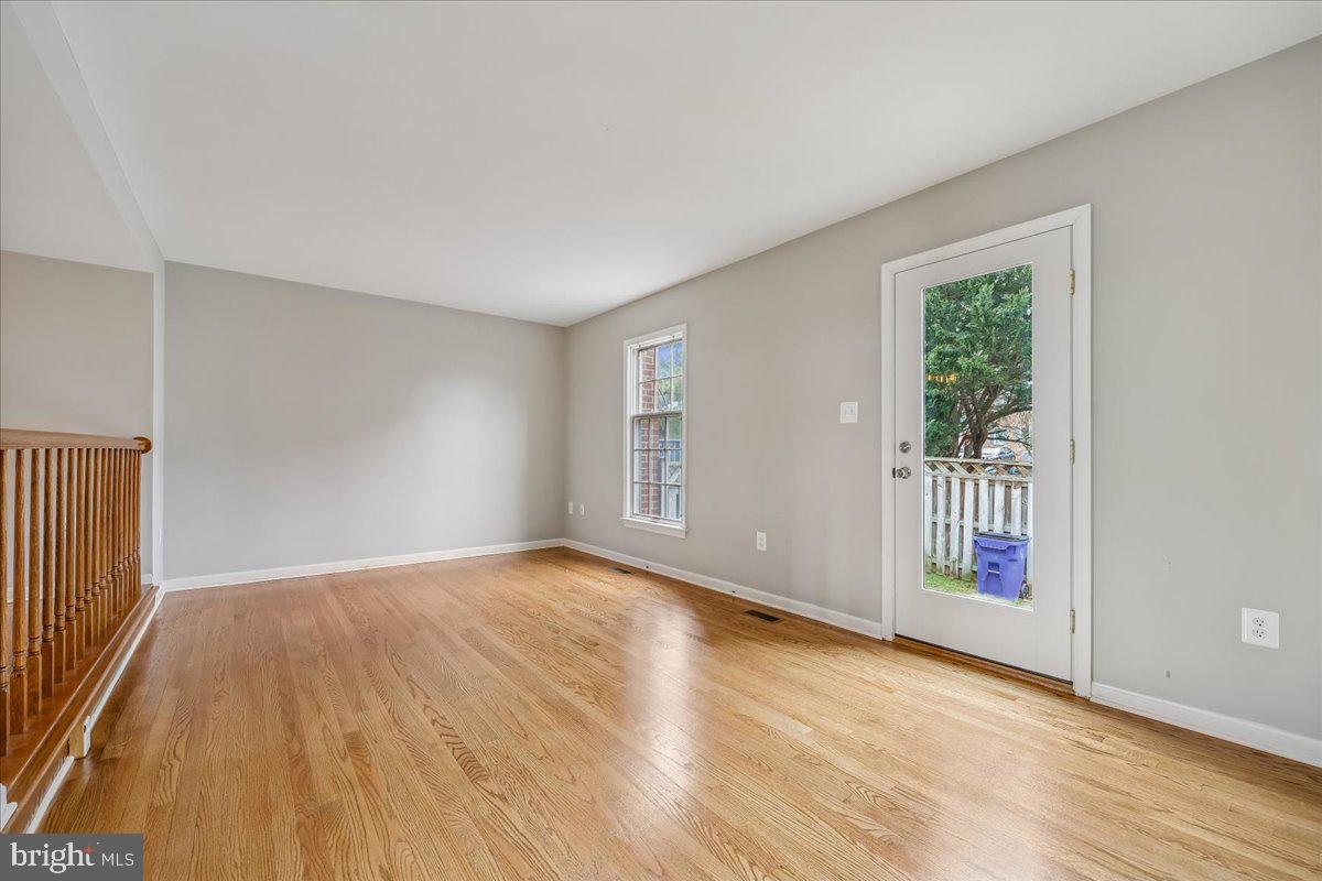 8024 Waterview Court Frederick, MD 21701 - Photo 13 of 72 a view of an empty room with wooden floor and a window