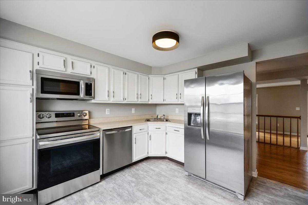 8024 Waterview Court Frederick, MD 21701 - Photo 2 of 72 a kitchen with a sink stainless steel appliances and cabinets