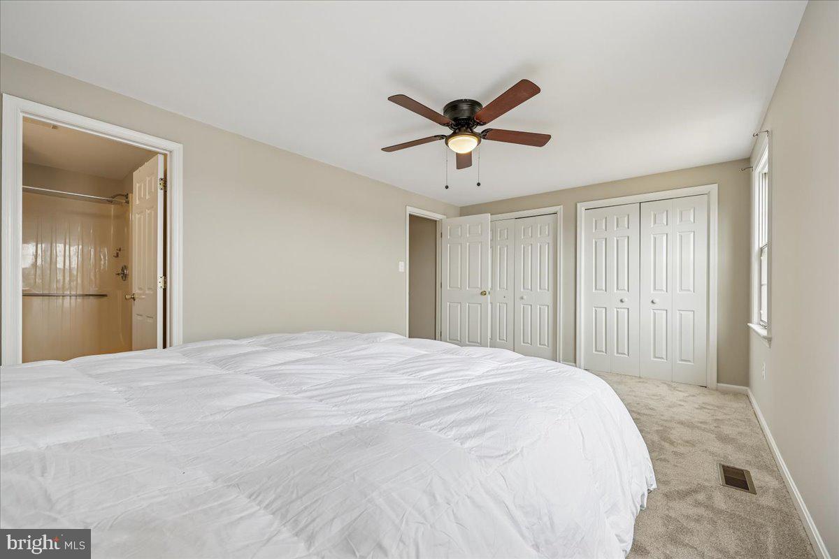 8024 Waterview Court Frederick, MD 21701 - Photo 21 of 72 a view of a bedroom with a bed and a chandelier