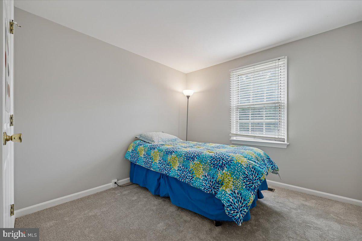 8024 Waterview Court Frederick, MD 21701 - Photo 25 of 72 a bed sitting in a bedroom next to a window