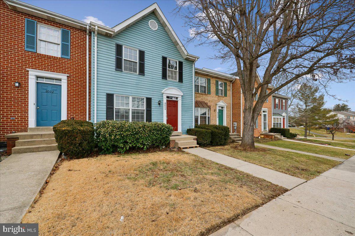 8024 Waterview Court Frederick, MD 21701 - Photo 46 of 72 a view of a white house next to a yard with large trees