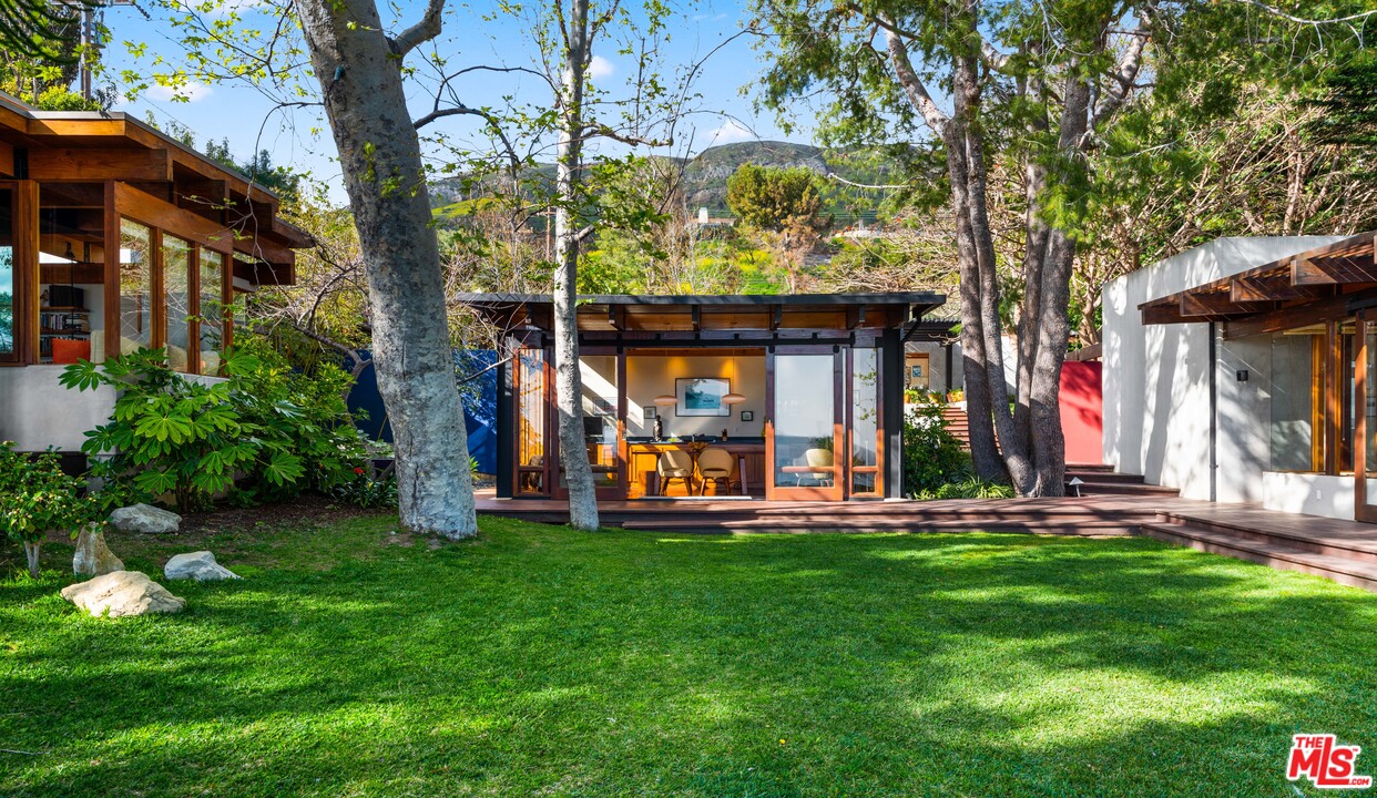 32496 Pacific Coast Highway Malibu, CA 90265 - Photo 15 of 51 a view of a chair and table in front of house