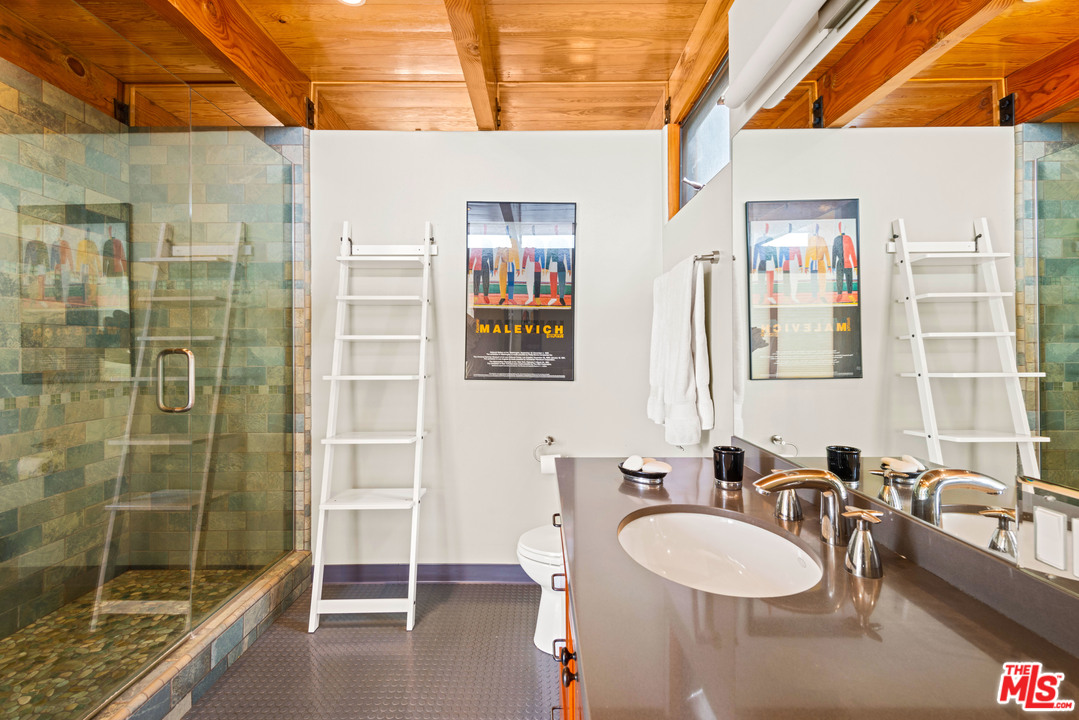 32496 Pacific Coast Highway Malibu, CA 90265 - Photo 43 of 51 a bathroom with a double vanity sink a mirror and a shower
