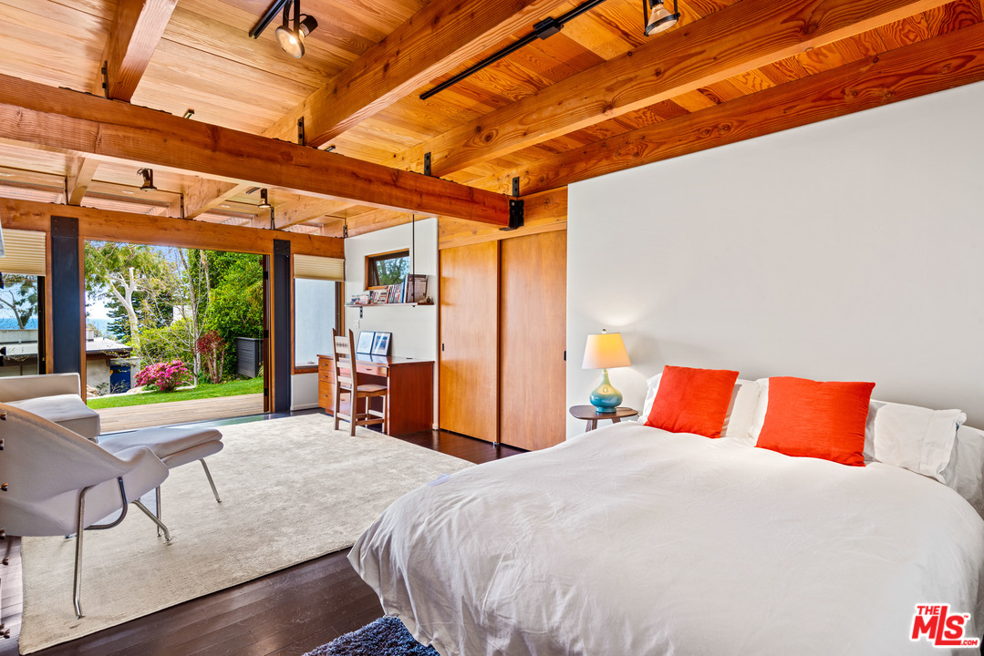 32496 Pacific Coast Highway Malibu, CA 90265 - Photo 45 of 51 a bedroom with a bed and large windows