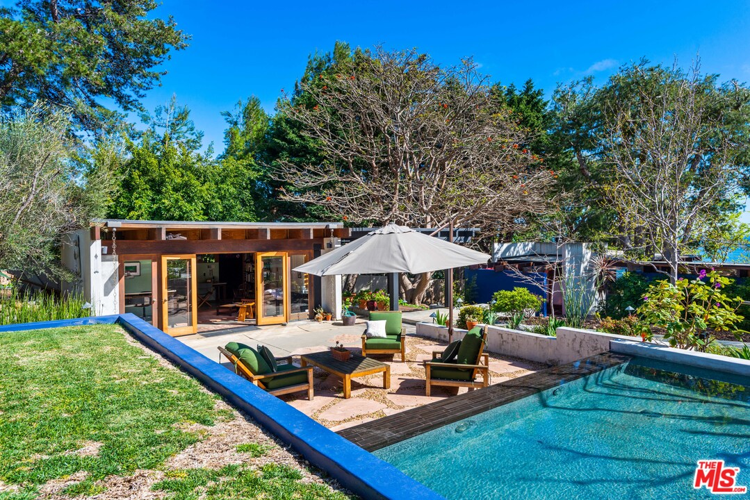 32496 Pacific Coast Highway Malibu, CA 90265 - Photo 48 of 51 a view of a house with backyard sitting area and garden