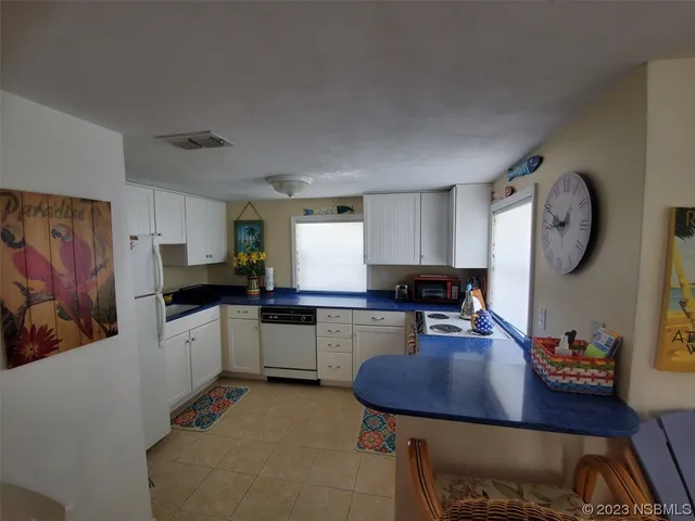 a kitchen with sink cabinets and window