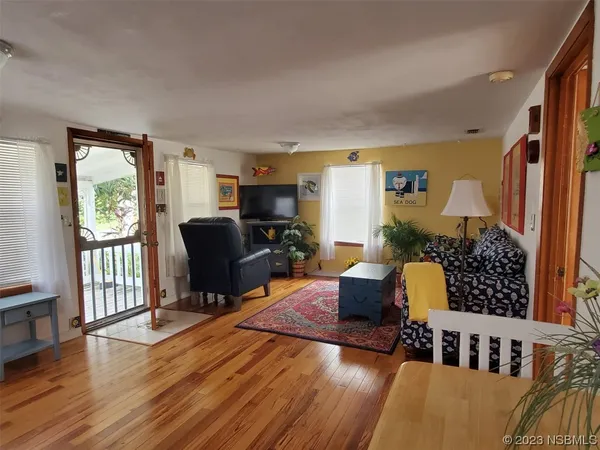 a living room with furniture window and wooden floor
