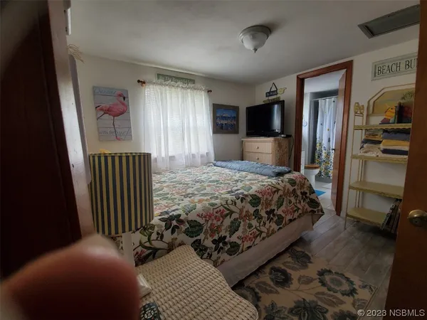 a bedroom with a bed and a television