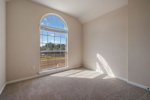 a view of a livingroom with wooden floor and a window