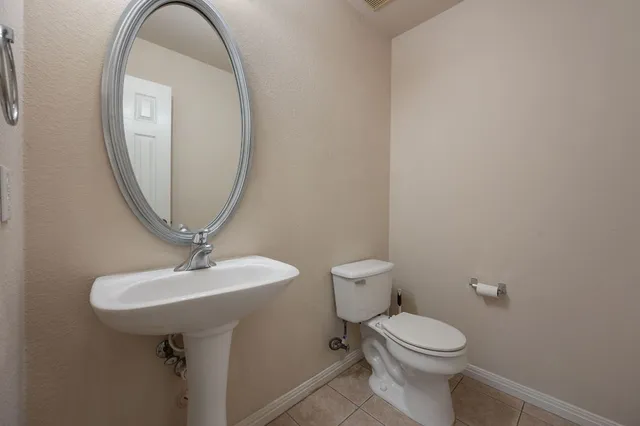 a bathroom with a toilet a sink and a mirror