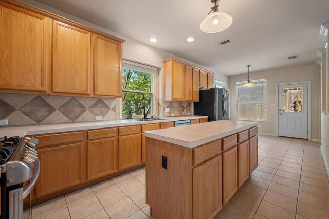 a kitchen with a sink and cabinets