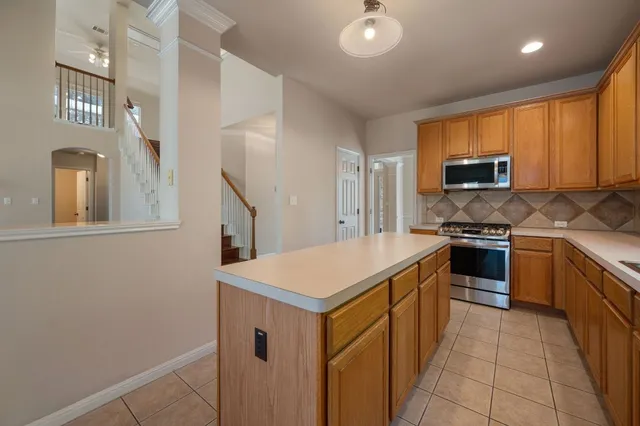 a kitchen that has a sink and a stove in it