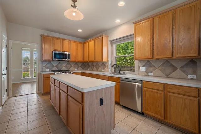 a kitchen that has a sink and a stove in it