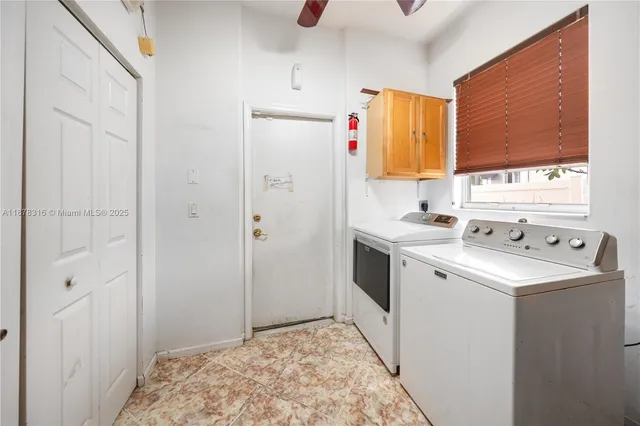 a view of walk in closet with clothes