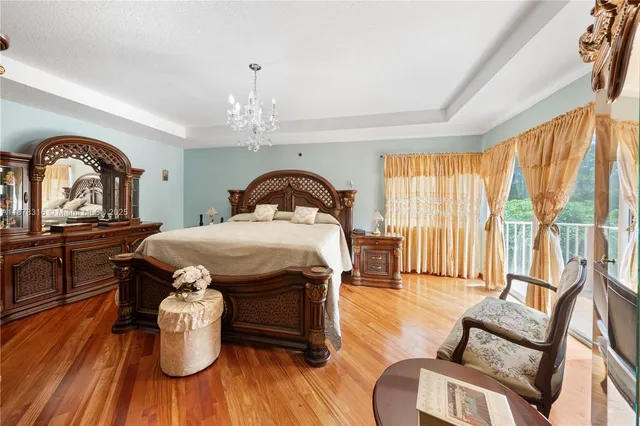 a bedroom with furniture and a large window