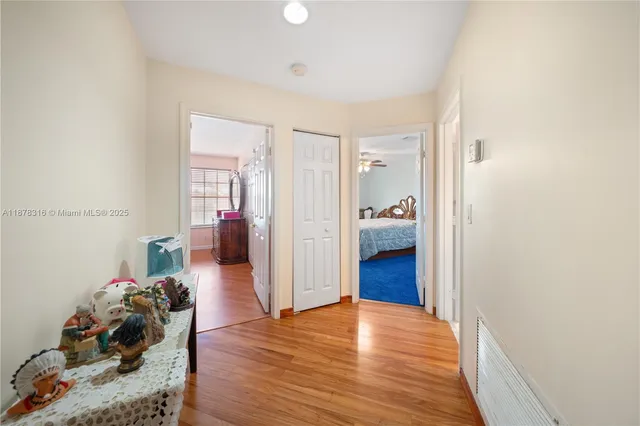 a view of a patio with table and chairs potted plants with wooden floor and fence