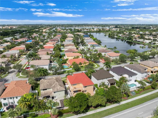 an aerial view of a house with outdoor space and a lake view