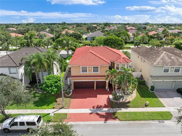 an aerial view of residential houses with outdoor space